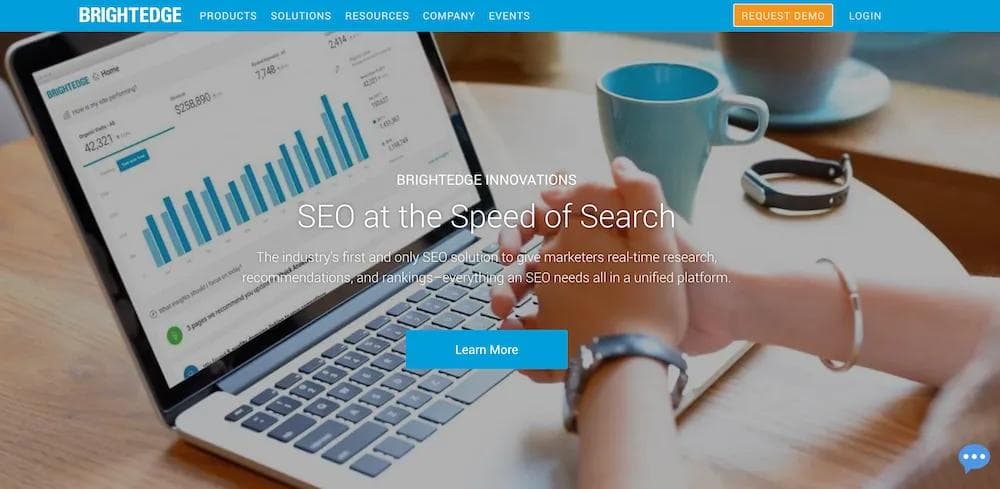 brightedge A person using a laptop to view SEO analytics with a coffee cup nearby, showcasing BrightEdge's platform features.